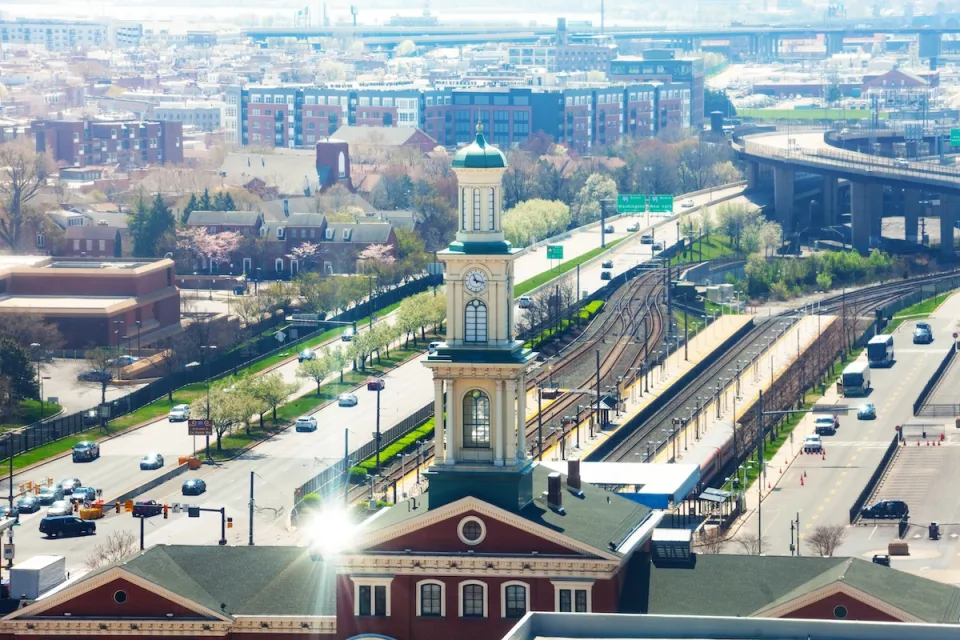 Aerial view of Camden Station train station in Baltimore, Maryland. Train station is brick neoclassical building with three-tier tower.